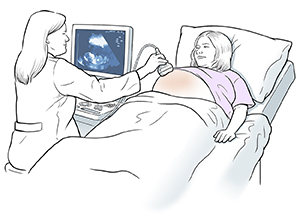 Healthcare provider performing ultrasound on pregnant woman.