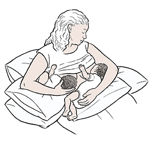 Woman breastfeeding twins.
