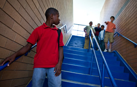 Boy being threatened or teased on the stairs at school