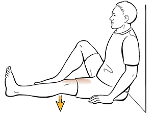 Man sitting doing quadriceps sets.