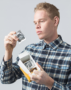 Man holding box of condoms.