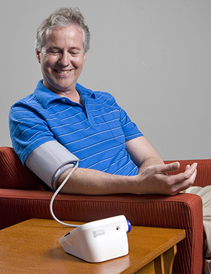 Man measuring his blood pressure at home.