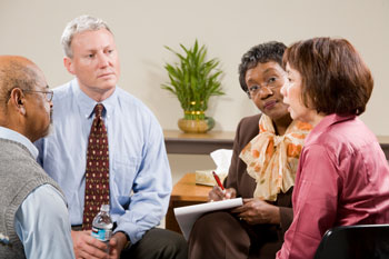 Woman talking with counselor and support group