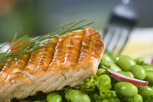 Broiled salmon with herbs on bed of edamame.