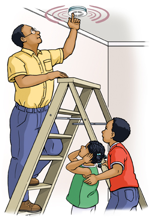 Man on ladder pressing button on ceiling smoke alarm. Two children standing nearby watching.