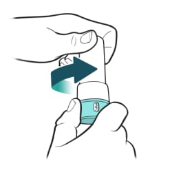 One hand holding bottom of inhaler with other hand twisting cap counter-clockwise to load medicine.