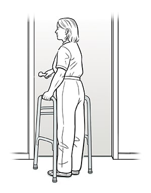 Female with walker pushing door open preparing to walk through.